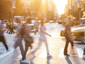 people crossing a busy urban street