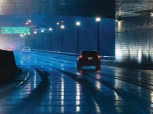 car driving through a road tunnel in the rain