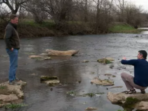 scientists looking at a river