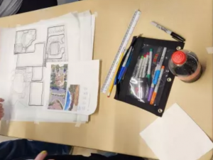 drawings and art supplies on a table