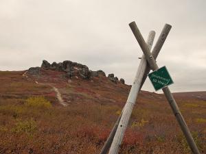 village marker and rock formation