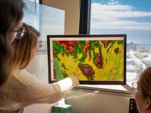 scientists looking at a satellite image