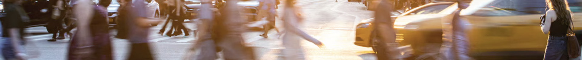 people crossing a busy urban street