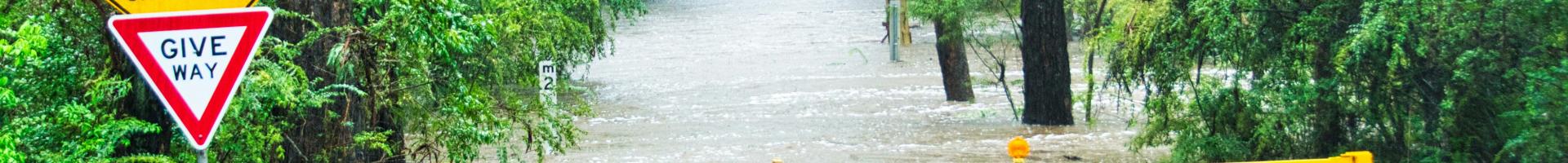 Flooded road and caution sign