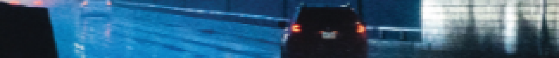 car driving through a road tunnel in the rain