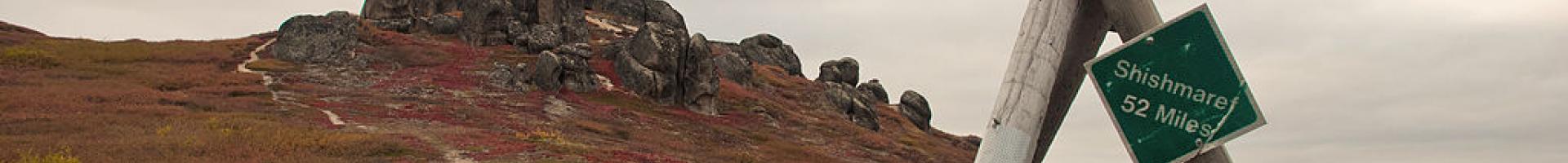 village marker and rock formation