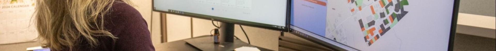 scientist working with GIS on computer