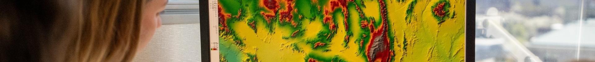 scientists looking at a satellite image