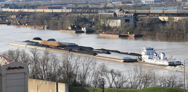 Photo of a river barge filled with coal and sand