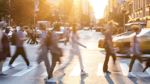 people crossing a busy urban street