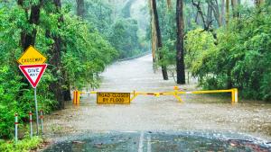 Flooded road and caution sign