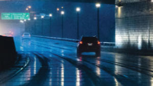 car driving through a road tunnel in the rain
