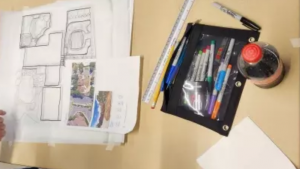 drawings and art supplies on a table
