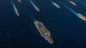 A picture of battleships at sea travelling in the same direction