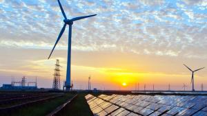 solar panels and windmills with sunset