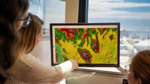 scientists looking at a satellite image