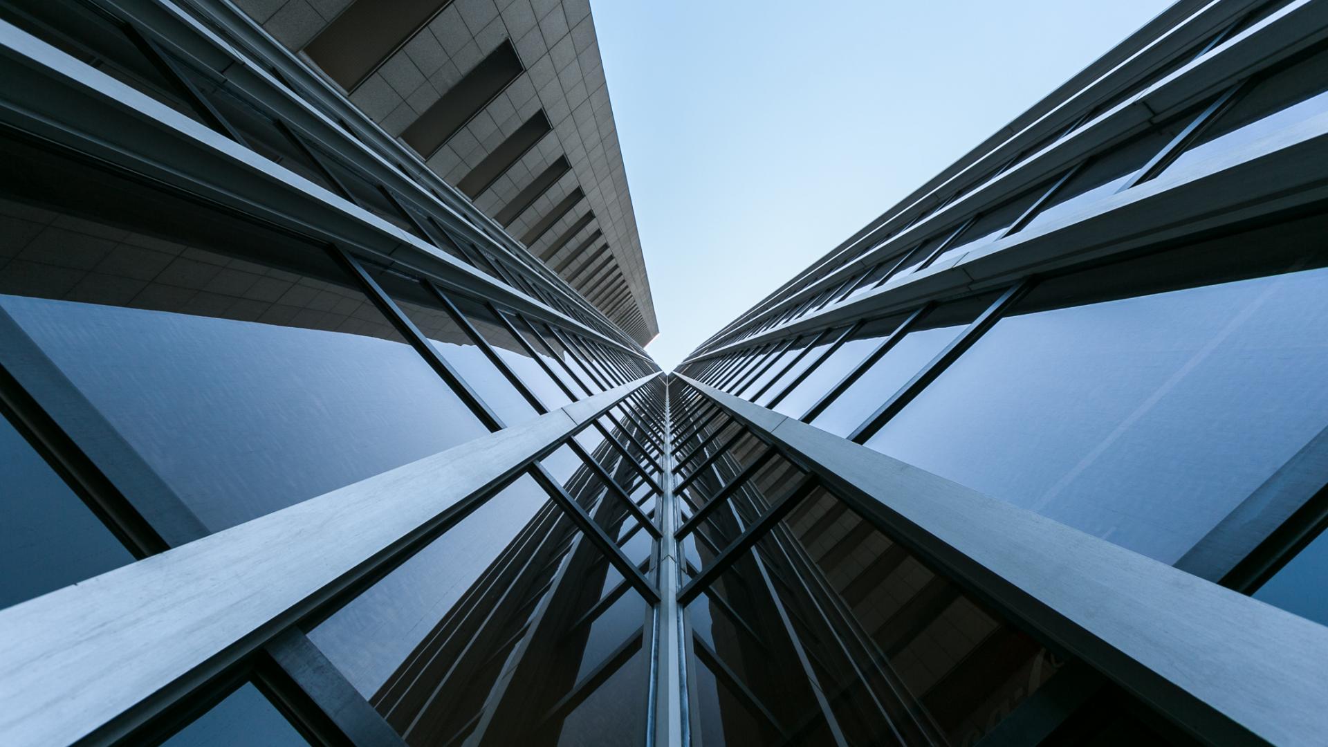 View looking up at a glass high rise building