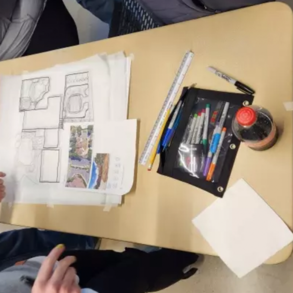 drawings and art supplies on a table