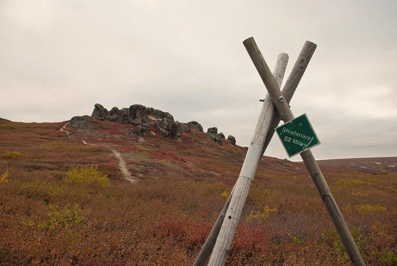 village marker and rock formation