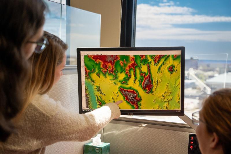 scientists looking at a satellite image