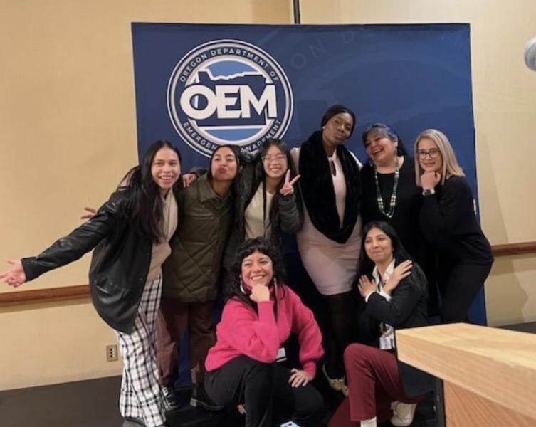 Eight people in front of a banner reading OEM