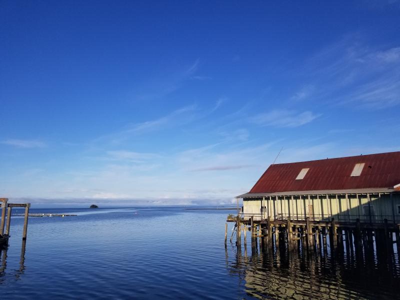 Blue sky and calm water around a historic building