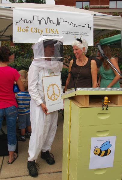 Pollinator advocate Phyllis Stiles (right) promotes Bee City USA