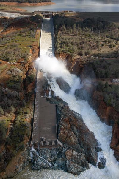 Water flowing down and out of damaged spillway