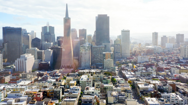 Close city buildings, one with a pyramidal top