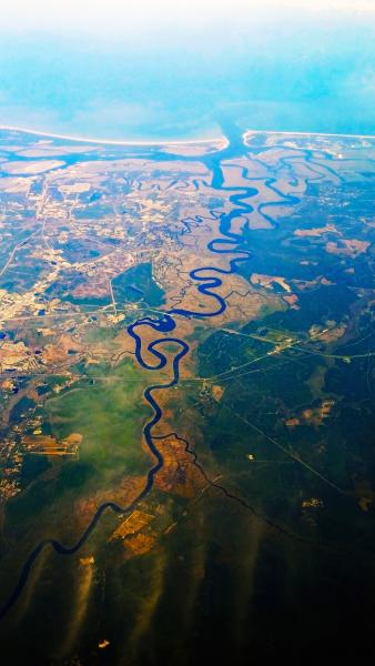 Aerial view of river flowing to ocean