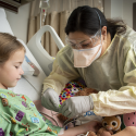 doctor caring for a young girl in the hospital