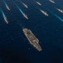 A picture of battleships at sea travelling in the same direction